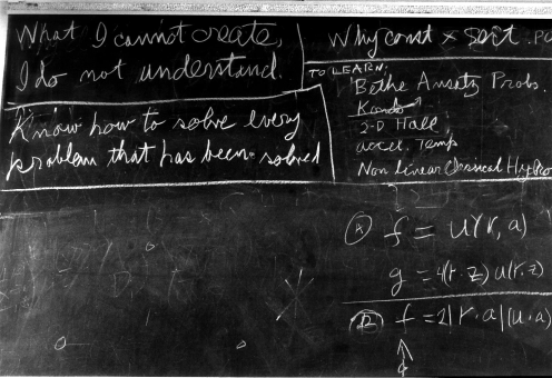 Two sentences written on a blackboard: 'What I cannot create I do not understand,' and 'Know how to solve every problem that has been solved.'